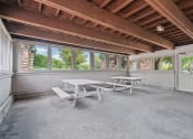 Thumbnail 20 of 22 - a patio with two picnic tables and windows in a house