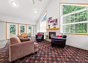 Thumbnail 4 of 16 - A living room with a fireplace and a couch.