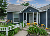 Thumbnail 1 of 8 - A blue house with the number 2226 on the front door.