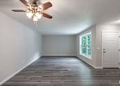 Thumbnail 5 of 8 - A room with a ceiling fan and a door.