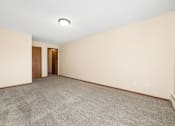 Thumbnail 14 of 15 - A room with a carpeted floor and two doors.