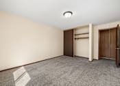 Thumbnail 13 of 15 - A room with a carpeted floor and a wall-mounted light fixture.