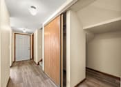 Thumbnail 4 of 15 - A hallway with a white door and a brown door.