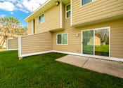 Thumbnail 3 of 15 - A house with a tan siding and a green lawn.