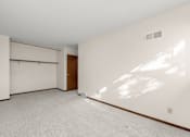 Thumbnail 9 of 14 - A large empty room with a door and a window.