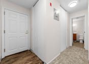 Thumbnail 4 of 23 - A white door with a gold handle is on the left.
