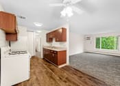 Thumbnail 5 of 23 - A kitchen with wooden cabinets and a white stove.
