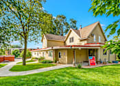 Thumbnail 16 of 18 - A house with a red sign in front of it.