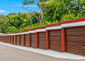 Thumbnail 15 of 18 - A long row of brown garage doors.