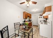 Thumbnail 5 of 15 - A kitchen with a table and chairs.