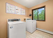Thumbnail 15 of 15 - A laundry room with a washer and dryer and instructions on the wall.