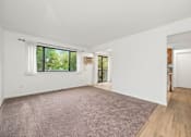 Thumbnail 3 of 15 - A room with a carpeted floor and a window with blinds.