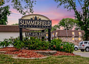 Thumbnail 10 of 15 - A sign for Summerfield Apartments is displayed in front of a building.