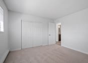 Thumbnail 13 of 22 - a bedroom with two closets and a door to a bathroom