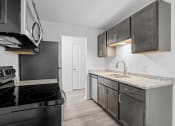 Thumbnail 9 of 22 - the spacious kitchen of our studio apartment atrium with stainless steel appliances