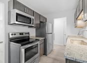 Thumbnail 8 of 22 - a kitchen with stainless steel appliances and granite counter tops and