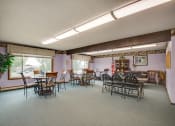 Thumbnail 9 of 14 - a dining room with tables and chairs and a large window