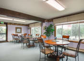 Thumbnail 12 of 14 - a dining room with tables and chairs and large windows