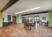 Thumbnail 11 of 14 - a dining room with a wooden table and chairs