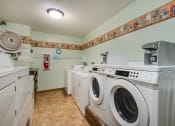 Thumbnail 14 of 14 - a laundry room with washing machines and other appliances