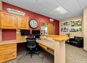 Thumbnail 15 of 23 - A red wall with a clock and a wooden cabinet.