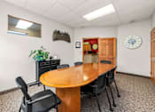 Thumbnail 23 of 23 - A conference room with a wooden table and chairs.