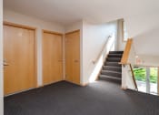 Thumbnail 4 of 6 - the entrance to a building with a staircase and two doors