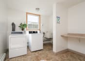 Thumbnail 5 of 6 - a washer and dryer in a laundry room with a sink and a window