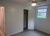 Thumbnail 8 of 10 - A room with a ceiling fan and a window.