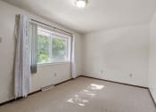 Thumbnail 15 of 21 - an empty room with a window and a curtain