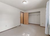 Thumbnail 17 of 21 - an empty living room with a door to a closet