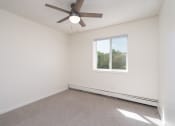 Thumbnail 14 of 27 - an empty room with a ceiling fan and a window