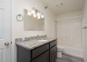 Thumbnail 16 of 27 - a bathroom with a sink and a toilet and a shower