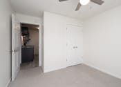 Thumbnail 18 of 27 - an empty bedroom with white walls and a ceiling fan