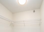 Thumbnail 21 of 27 - an empty room with a white wall and a ceiling light