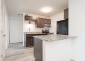 Thumbnail 12 of 27 - a kitchen with a marble counter top and a refrigerator