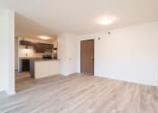Thumbnail 15 of 27 - the living room and kitchen of an apartment with wood flooring
