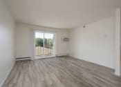 Thumbnail 10 of 27 - an empty living room with a door to a balcony