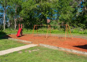 Thumbnail 6 of 27 - a swing set with a red slide in a park