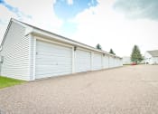 Thumbnail 14 of 14 - a row of white garage doors on the side of a building