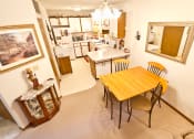 Thumbnail 10 of 14 - a dining room and kitchen with a wooden table and chairs