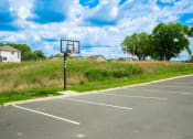 Thumbnail 20 of 22 - a basketball hoop in an empty parking lot