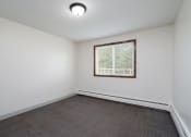Thumbnail 14 of 22 - the living room of an empty home with a window and wood flooring