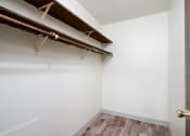 Thumbnail 18 of 22 - an empty closet in a room with wood flooring and white walls