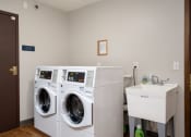 Thumbnail 22 of 22 - a laundry room with a washing machine and a sink