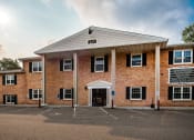 Thumbnail 1 of 12 - the front of a brick building with a porch
