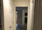 Thumbnail 9 of 16 - a hallway with a white door and a hall way