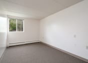 Thumbnail 14 of 21 - an empty room with white walls and a window