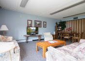 Thumbnail 2 of 21 - a living room with couches a table and a television