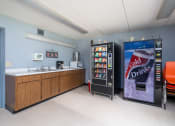 Thumbnail 4 of 21 - a snack room with a vending machine and a sink and a coke refrigerator